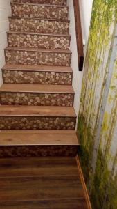 a staircase with wood treads and a green wall at Ferienwohnung für 5 Personen ca 52 qm in Sankt Englmar, Bayern Bayerischer Wald in Sankt Englmar