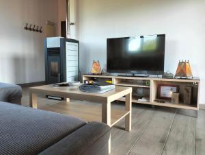 a living room with a television and a coffee table at La Casa de Nuria in Cangas de Onís
