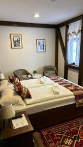 a bedroom with two beds and a table at Apartments HAN Alifakovac-Sarajevo in Sarajevo