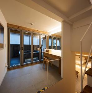 a room with a dining table and a balcony at Luxury Hanok Serenity Villa in Seoul