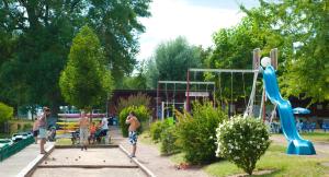 a group of children playing on a playground at Spacieuse maison de village in Luché-Pringé