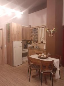 a kitchen with a table and a white refrigerator at Maria's Paradise in Vonitsa