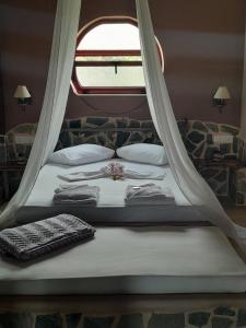 a bedroom with a bed with a window at Maria's Paradise in Vonitsa