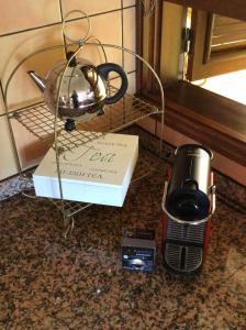 CasaquemadaにあるCasa Visioneros Tijarafe LaPalmaのコーヒーメーカーの隣のカウンターの上にティーポットと箱が置かれている