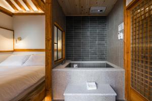 a room with a bed and a bath tub at Luxury hanok with private bathtub - SN05 in Seoul