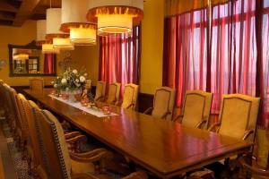 a long table and chairs in a room with red curtains at Four Fabulous 3BR Villa Unique View in Cabo in Cabo San Lucas +32 photos