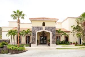 a house with palm trees in front of it at Four Fabulous 3BR Villa Unique View in Cabo in Cabo San Lucas