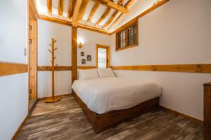 a bedroom with a bed in a room with wooden ceilings at Luxury hanok with private bathtub - SN04 in Seoul