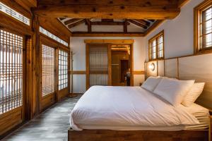 a bedroom with a bed in a room with windows at Luxury hanok with private bathtub - SN04 in Seoul