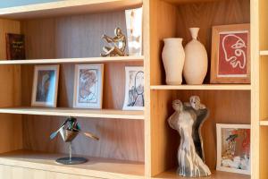 a wooden shelf with vases and pictures on it at Fuga Panorama in Bodrum City