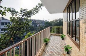 a balcony with two potted plants on it at Om villa in New Delhi