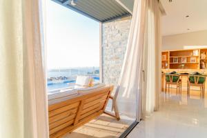 a living room with a large window with a view of the ocean at Fuga Panorama in Bodrum City