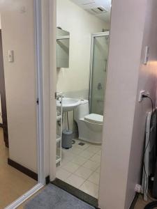 a bathroom with a toilet and a sink at Torre De Manila Stunning Apartment in Manila
