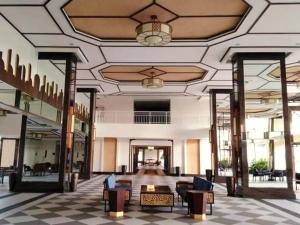 a lobby of a hotel with chairs and a ceiling at Torre De Manila Stunning Apartment in Manila