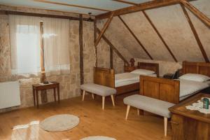 a room with two beds and a table and chairs at House of Culture and Nature - Hiša Kulture in Nature in Zagradec