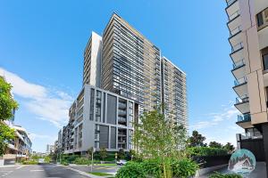 an architectural rendering of a tall building at Aircabin｜Wentworth Point｜Stylish Comfy｜2 Beds Apt in Sydney