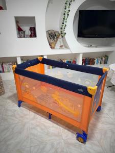 a baby crib with a toy in a room at FAR WEST in Ginosa