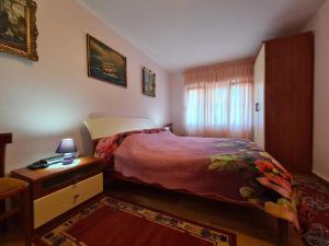 a bedroom with a bed and a table with a lamp at Ferienwohnung für 4 Personen ca 51 qm in Fažana, Istrien Istrische Riviera in Fažana +14 photos