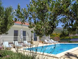 a villa with a swimming pool and a house at Ferienhaus mit Privatpool für 6 Personen ca 86 qm in Kaštel Gomilica, Dalmatien Kaštela und Umgebung in Kaštela