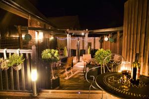 a patio at night with a table and chairs at Spire View at THE GALLEON RESTAURANT in Chesterfield