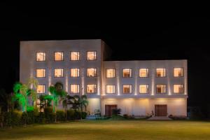 a large building at night with its lights on at Playotel Resort Bhopal in Bhopal