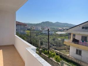 a balcony with a view of a city at Blendi Guest House in Golem