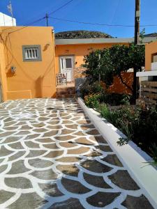 a house with a stone walkway in front of a building at Katerina's House in Sitia