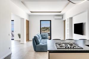 a living room with a couch and a stove at Suite San Montano by Feeling Italy in Massa Lubrense