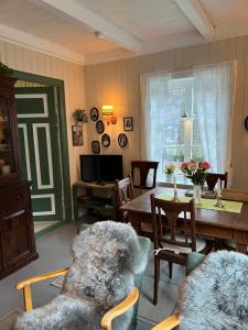a living room with a teddy bear sitting on a chair at Koselig feriehus, Birkedaltunet in Løvoll