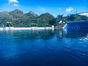 a pool of water with mountains in the background at Sapa Passion Hotel & Spa in Sapa