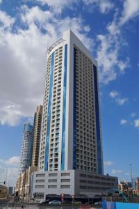 a tall building with blue and white at Immaculate 1BR at Burj Al Nujoom Downtown Dubai by Deluxe Holiday Homes in Dubai