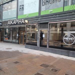 una tienda frente a un edificio con ventanas de cristal en Moi Aikatalo Hostel Helsinki, en Helsinki