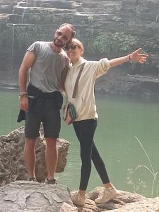 a man and a woman standing on a rock by the water at Holiday Home Stay in Khajurāho