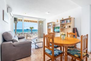 a living room with a table and a couch at Los Ranchos 1-3 Apartment Levante Beach in Benidorm