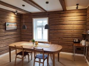 a dining room with wooden walls and a table and chairs at Privacy within city limits in Tartu