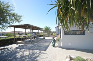 a small child standing in front of a pavilion at Chardon in Langebaan