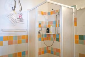 a shower in a bathroom with colorful tiles at """ Holiday Properties Sicilian Central """ in Avola +34 photos