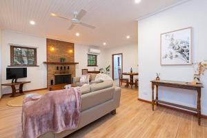 a living room with a couch and a fireplace at Blueberry Farm Cottage in Willunga