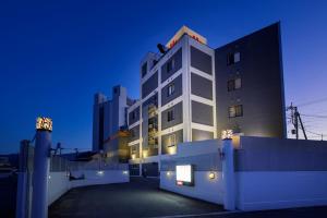 a tall white building at night with a blue sky at Happy Kiss (Adult Only) in Showa