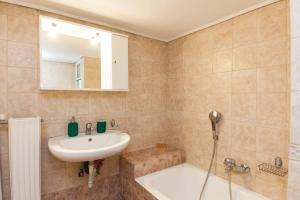 a bathroom with a sink and a bath tub and a sink at Luxury Pireas Stay New 2BR Urban Escape in Piraeus