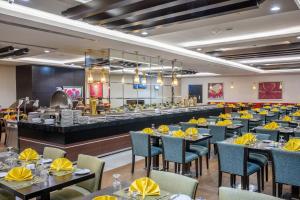 a dining room with tables and chairs and a buffet at Al Ghufran Safwah Hotel Makkah in Mecca