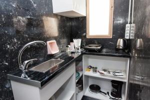 a kitchen with a sink and a counter top at Brand new 1 Bd Apt in Kolonaki in Athens