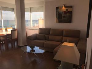 a living room with a couch and a table at Stunning views to the sea / City center Fuengirola in Fuengirola +18 photos