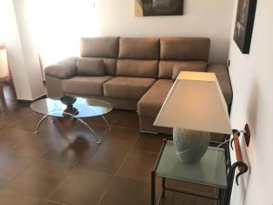 a living room with a couch and a table at Stunning views to the sea / City center Fuengirola in Fuengirola