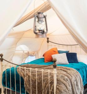 a bedroom with a bed in a tent at The Mahal a Majestic 4-Bedroom Glamping Palace! in Ross on Wye