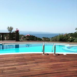 a swimming pool with a view of the ocean at Luxury Villa Nefeli w Private Pool In Skiathos in Troulos