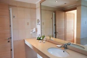 baño con lavabo y espejo grande en Luxury Villa Nefeli w Private Pool In Skiathos, en Troulos
