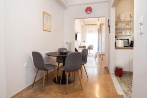 a kitchen and dining room with a table and chairs at Contemporary Stylish Apartment Located Near Metaxourgeio Area in Athens