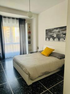 a bedroom with a bed with a yellow pillow at That's amoR in Rome