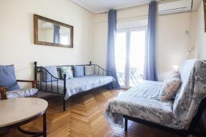 a living room with a couch and a table at Splendid Apt Located in the Historic Area of Exarcheia in Athens